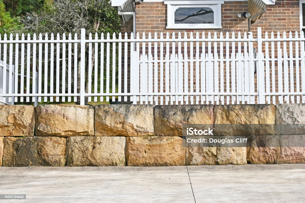 fence on top of retaining wall