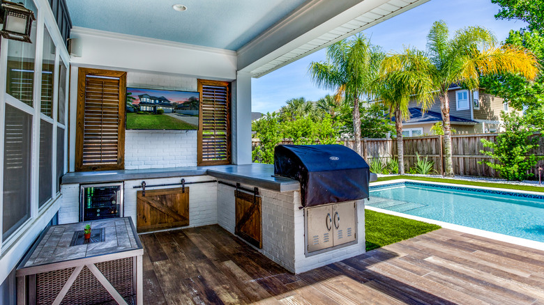 small backyard with pool and outdoor kitchen